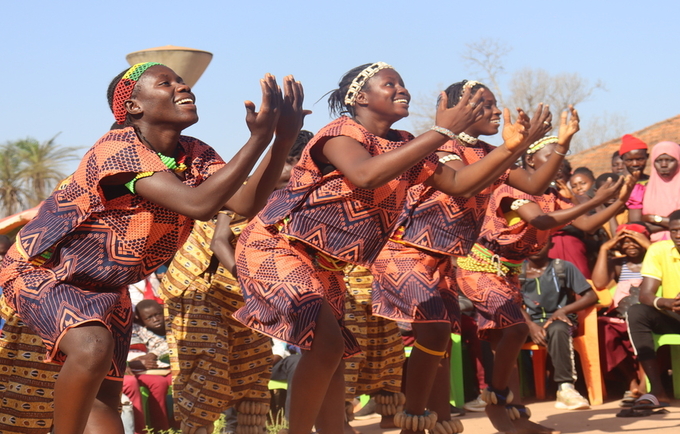 Members of Guinea-Bissau’s National Ballet, the Nossa Patria Amada, perform a dance scene at a local market in Bissorã